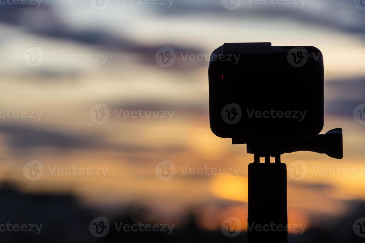 Silhouette Action camera in front of the twilight sky photo