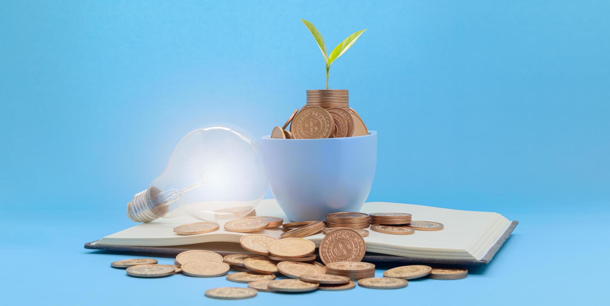 Saving money cup with lightbulb photo