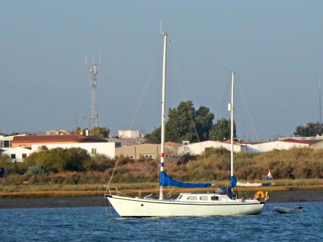 pequeño velero blanco cerca de la orilla foto