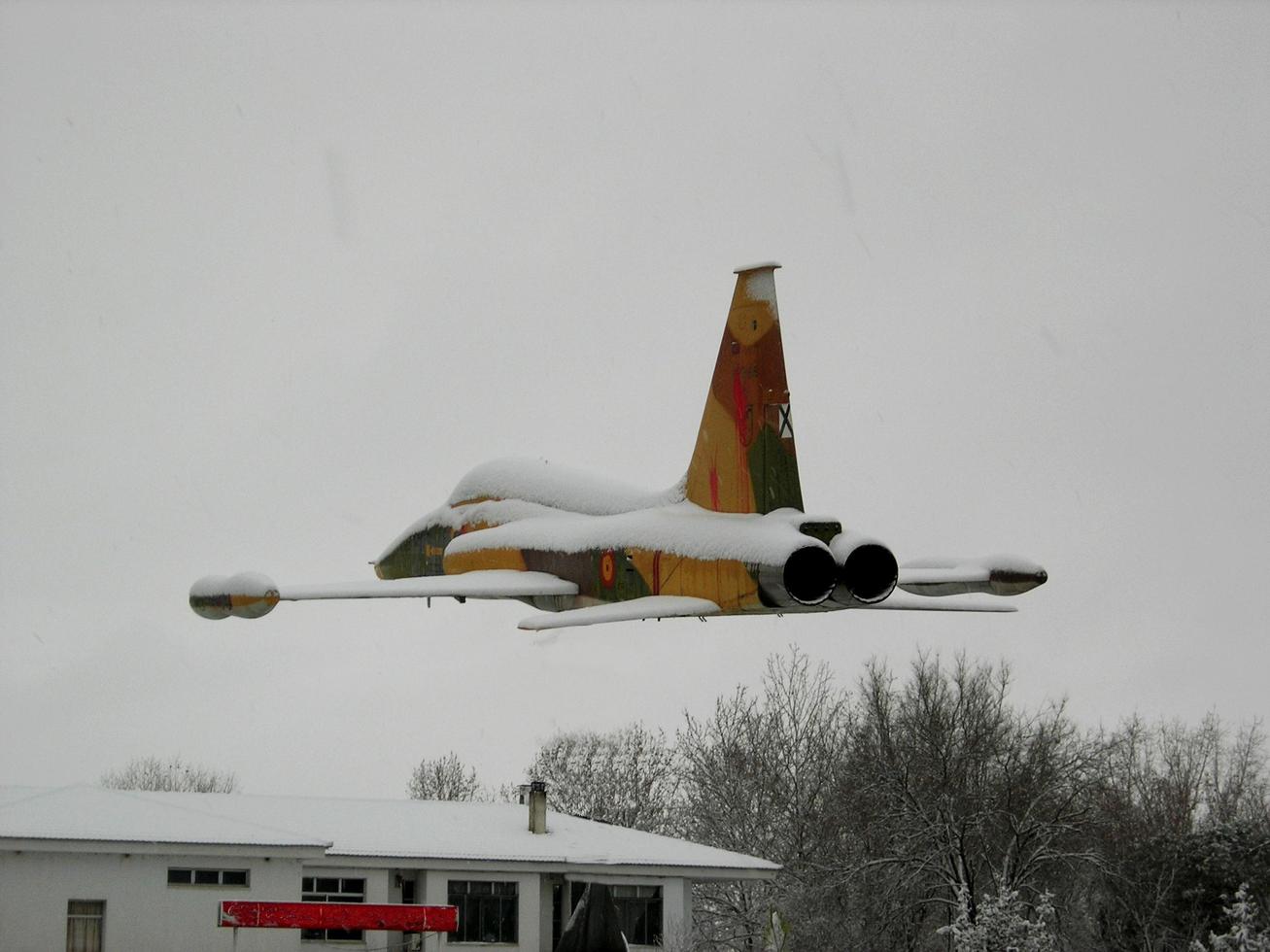 Soria, Spain, Sep 26, 2021 - War plane flying on a snowy day photo