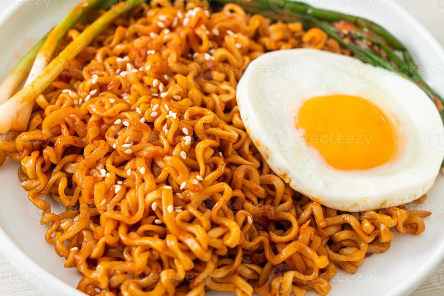 Dried Korean spicy instant noodles with fried egg photo