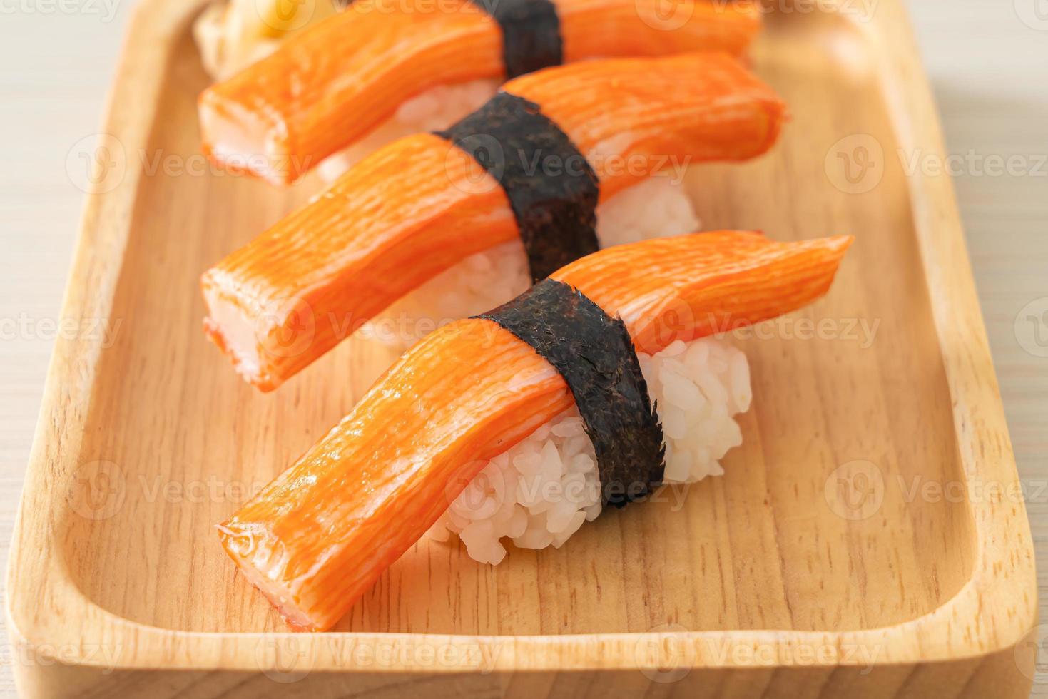 Crab stick sushi on wood plate photo