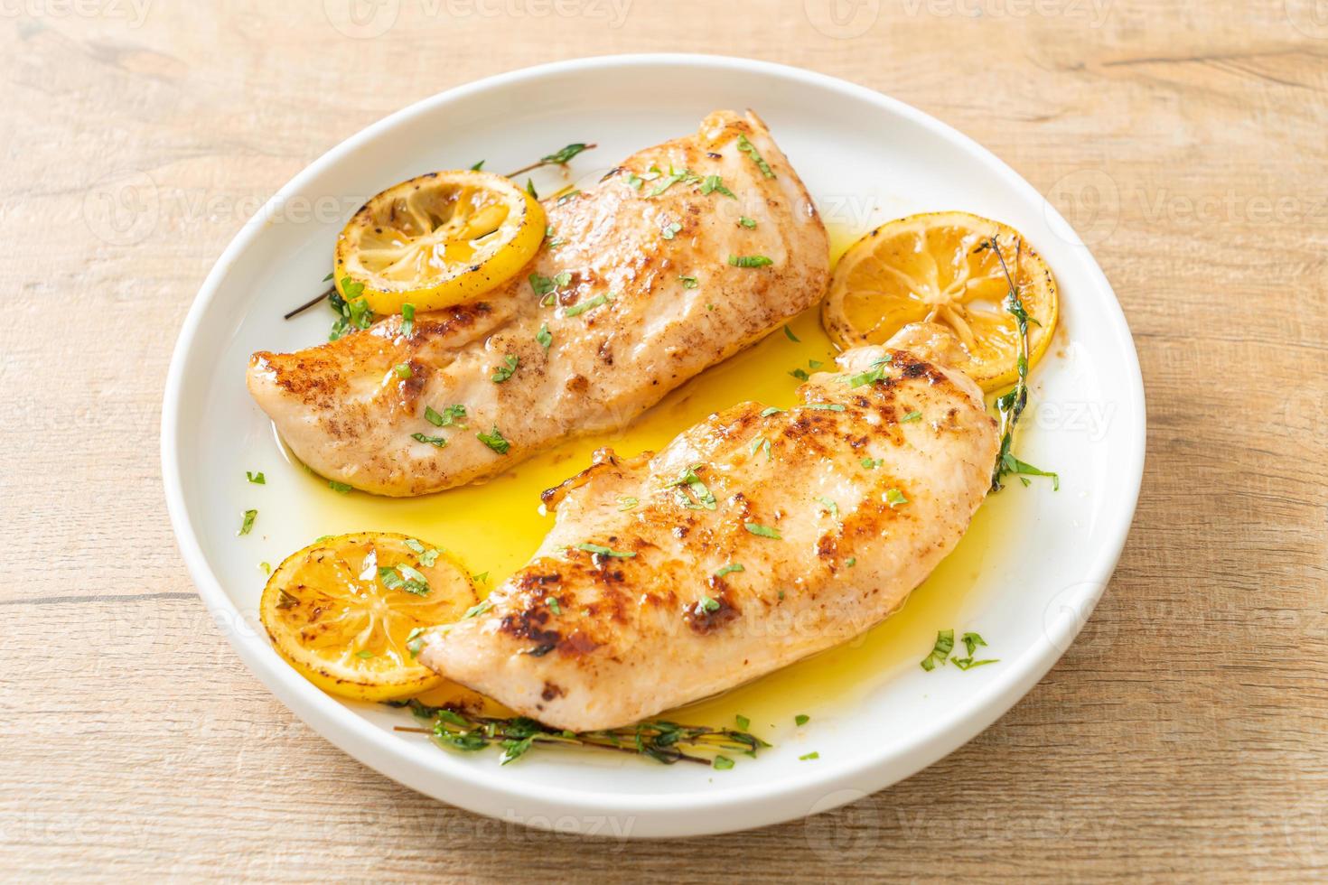 Grilled chicken with butter, lemon and garlic photo