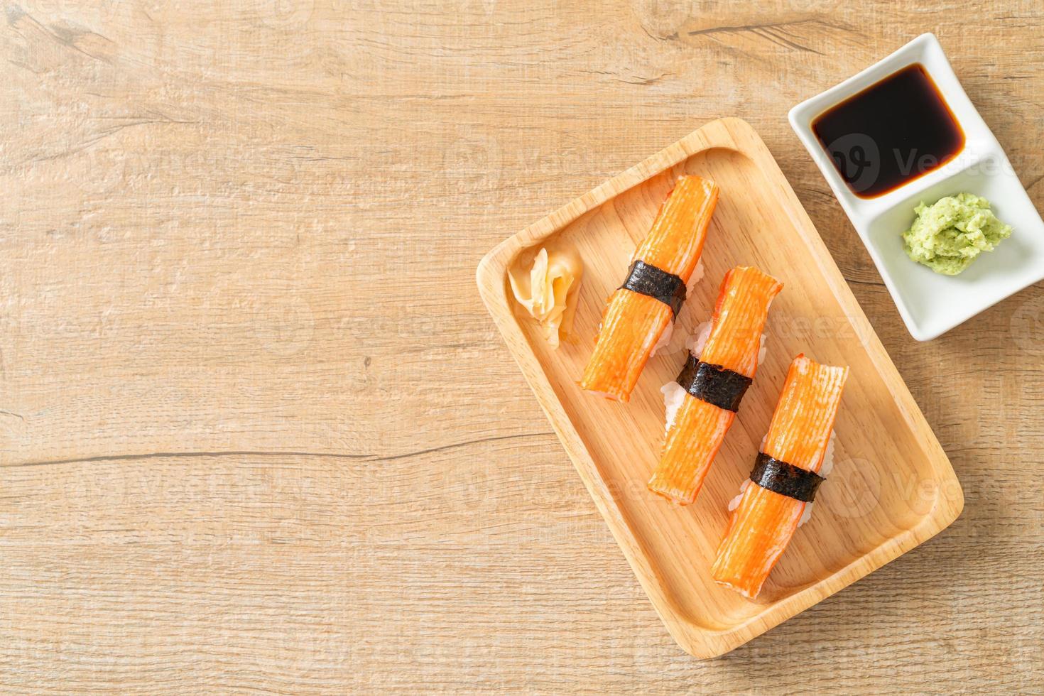 Crab stick sushi on wood plate photo