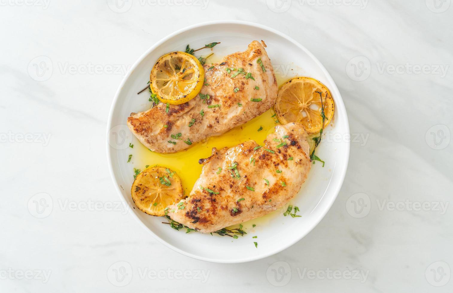 Grilled chicken with butter, lemon and garlic photo