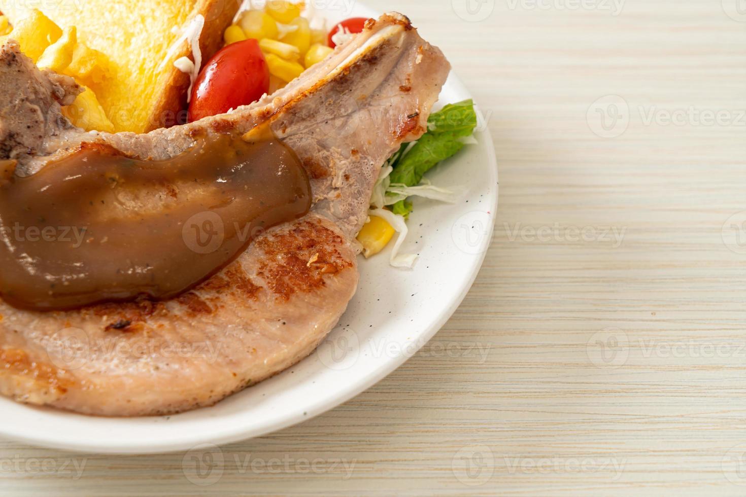 Pork chop steak with chips and mini salad photo