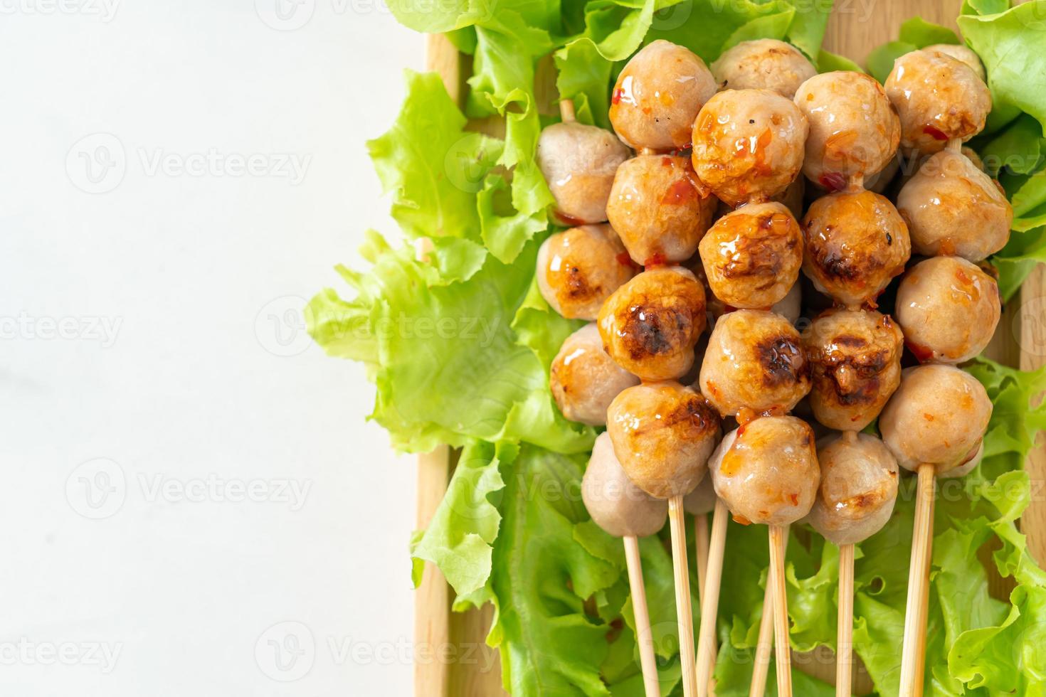 Grilled meatballs skewer with spicy sauce photo