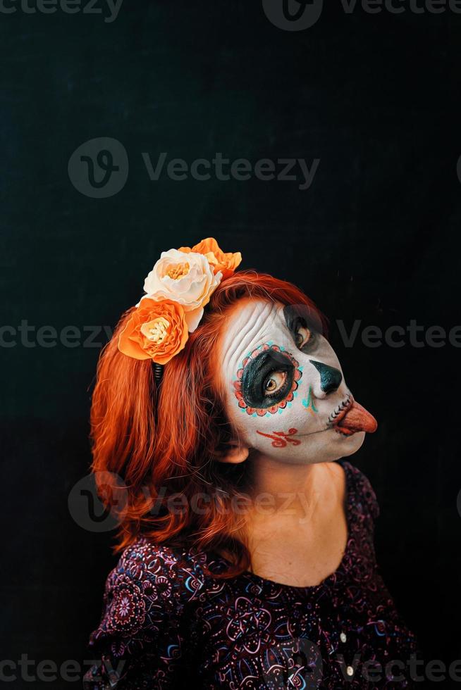 A young woman in day of the dead mask skull face art photo