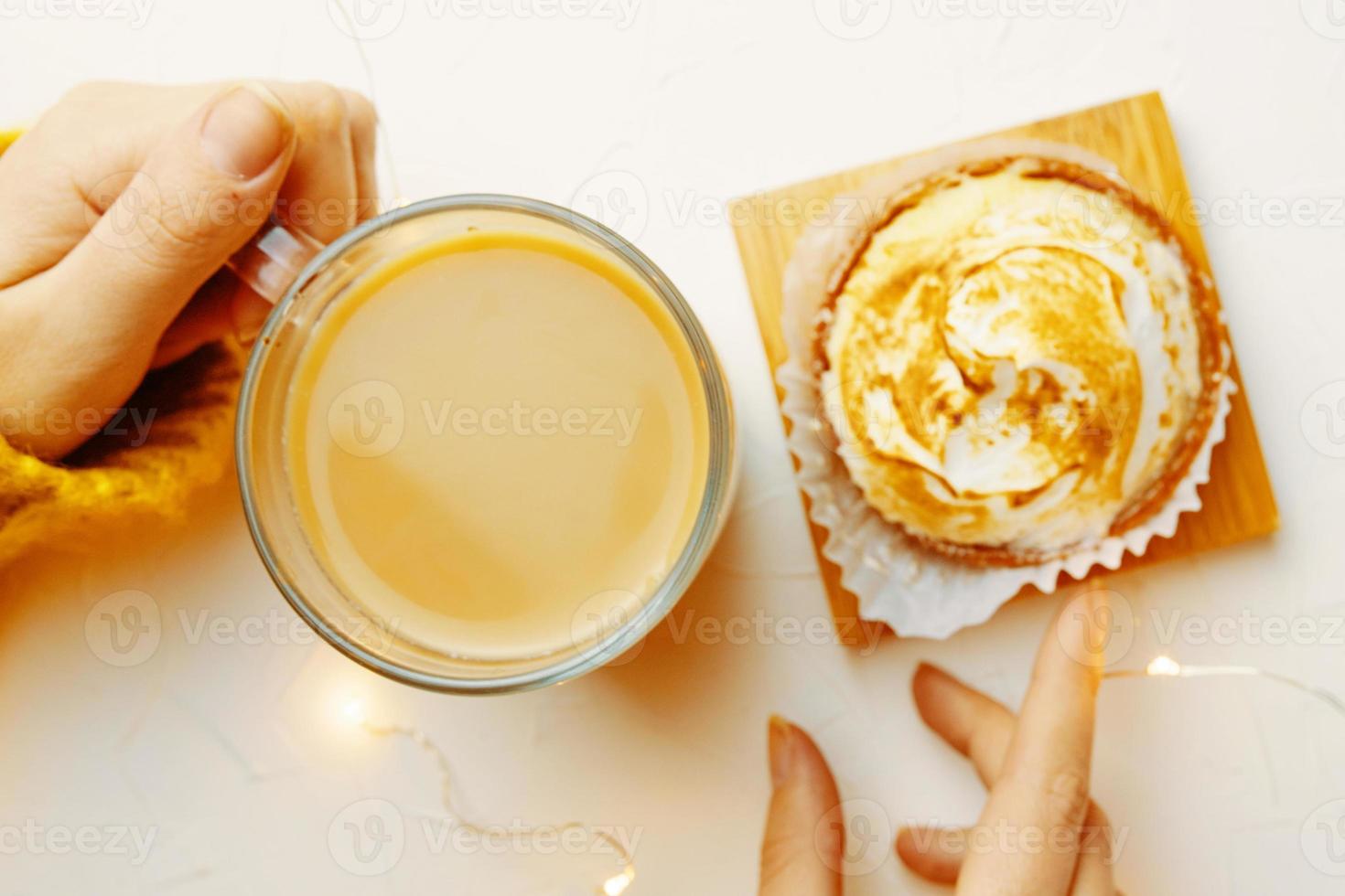 Top view of tartlet and coffee on white table photo