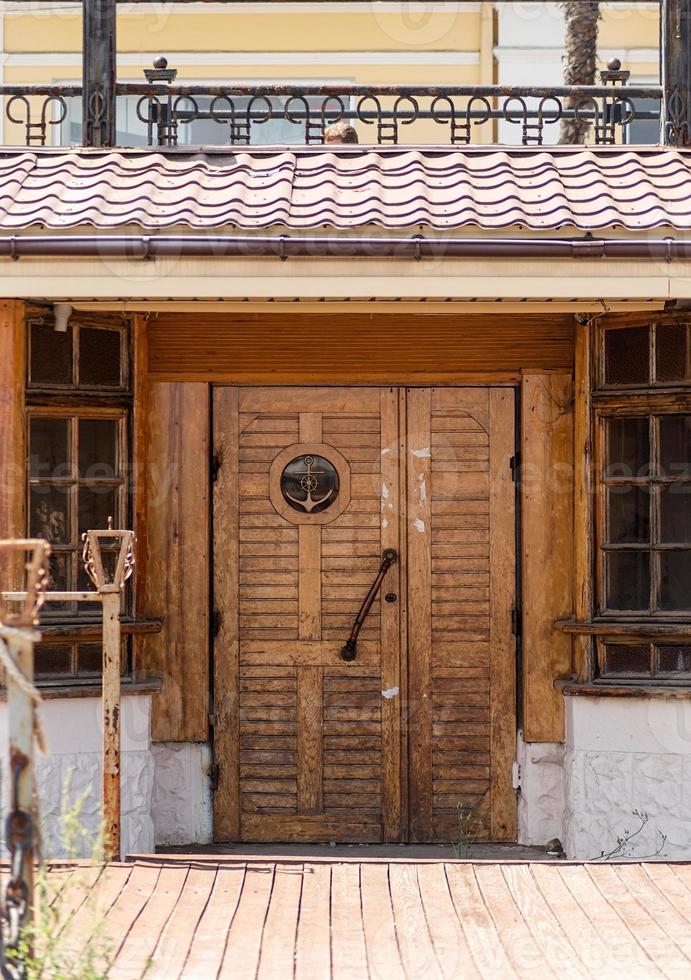 Old vintage wooden door with anchor in marine style photo