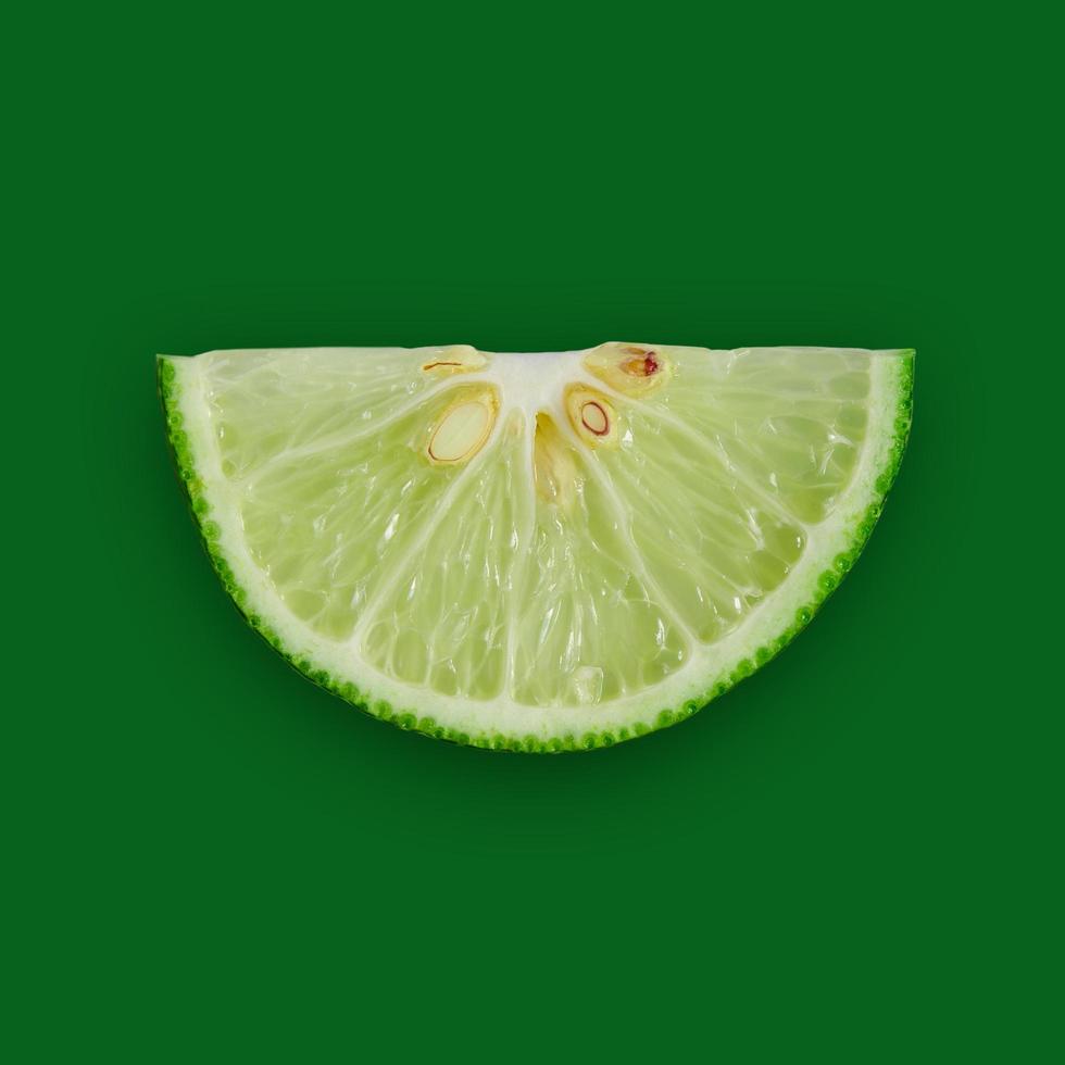 Lemon and lime slice and fresh citrus fruit on green background. photo
