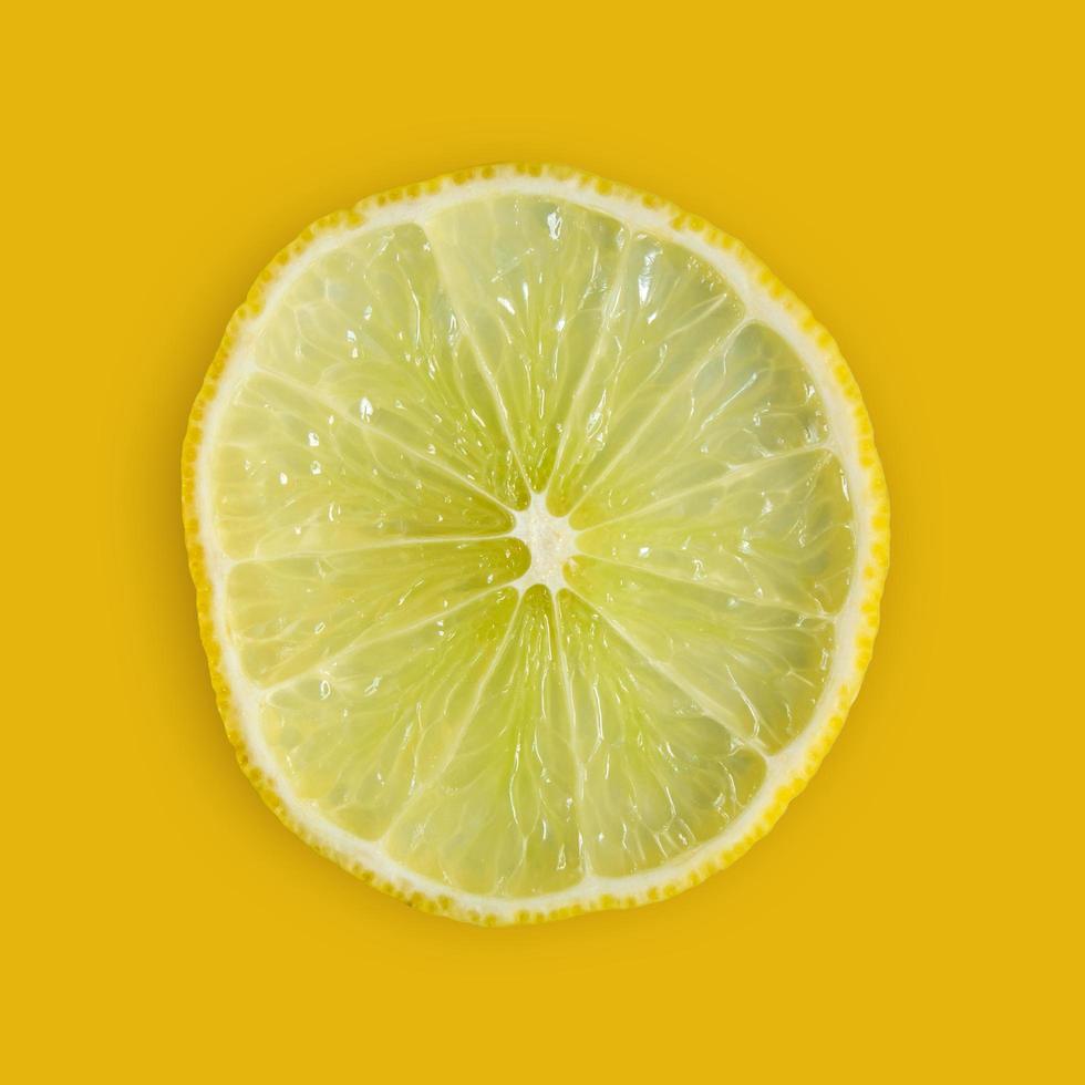 Lemon and lime slice and fresh citrus fruit on yellow background. photo