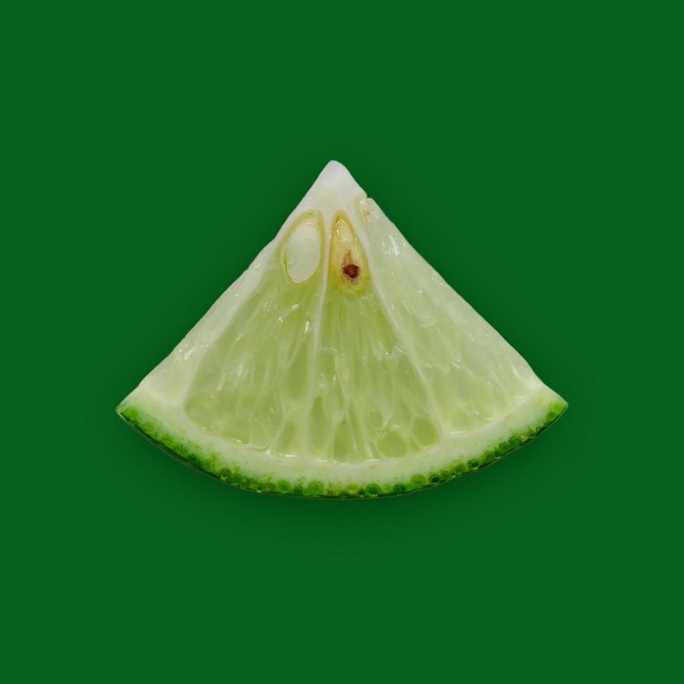 Lemon and lime slice and fresh citrus fruit on green background. photo