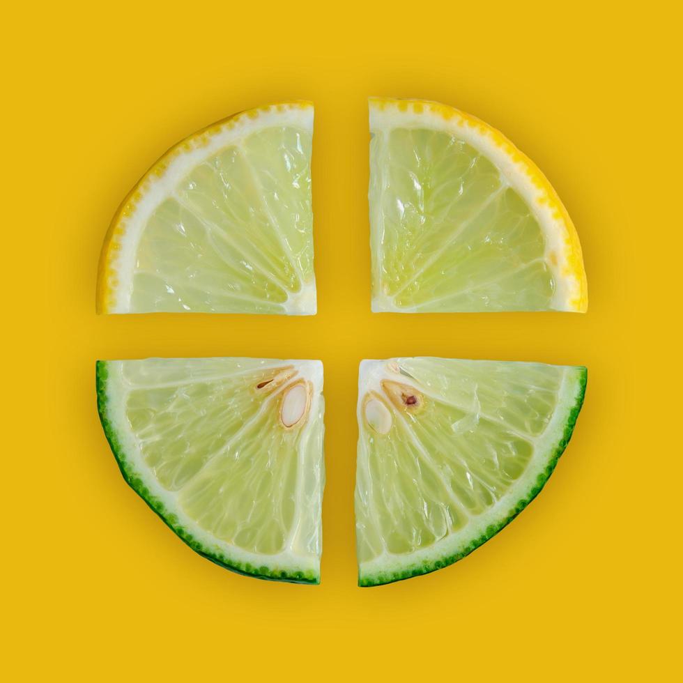Lemon and lime slice and fresh citrus fruit on yellow background. photo