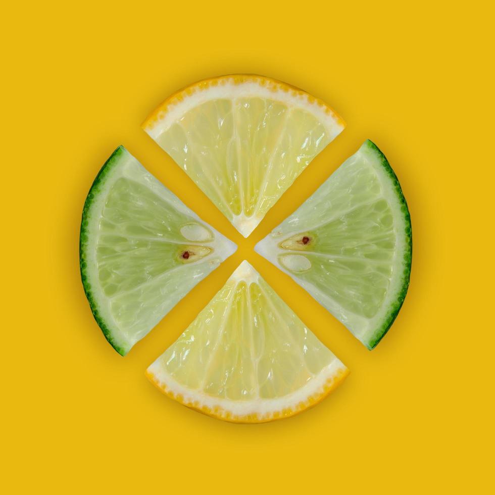 Lemon and lime slice and fresh citrus fruit on yellow background. photo