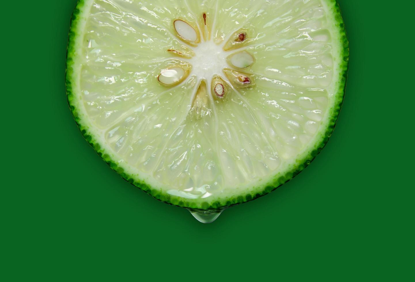 Lemon and lime slice and fresh citrus fruit on green background. photo