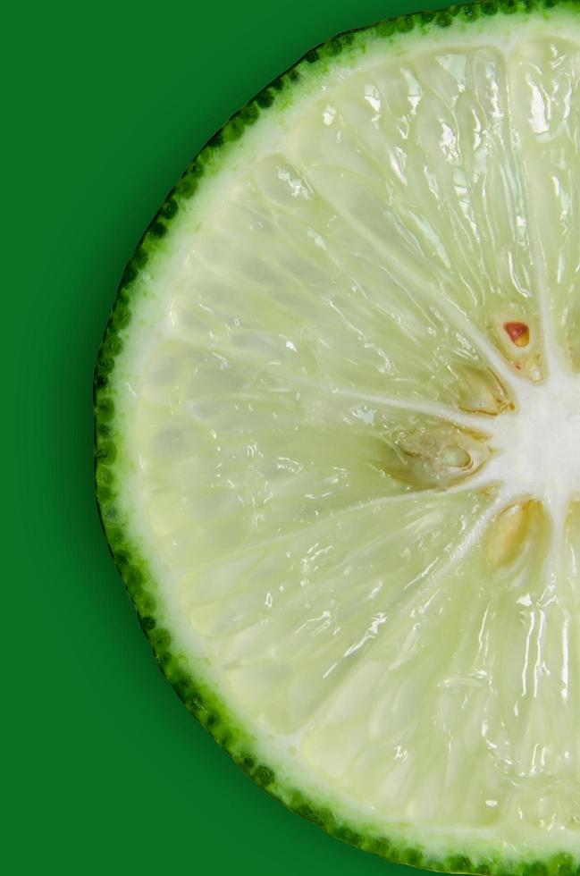 Lemon and lime slice and fresh citrus fruit on green background. photo