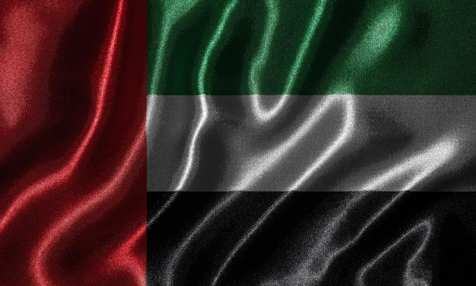 papel tapiz de la bandera de los Emiratos Árabes Unidos y bandera ondeando por la tela. foto