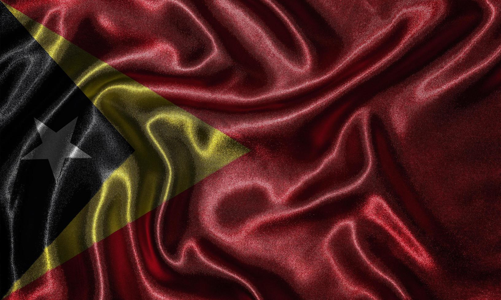 papel pintado por la bandera de timor leste y bandera ondeando por la tela. foto