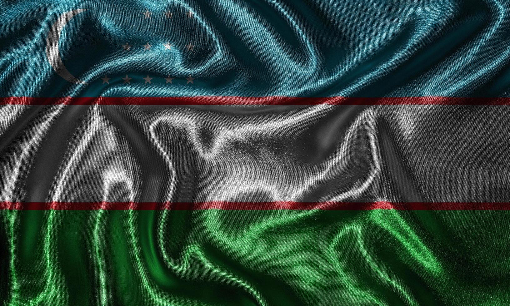 Wallpaper by Uzbekistan flag and waving flag by fabric. photo