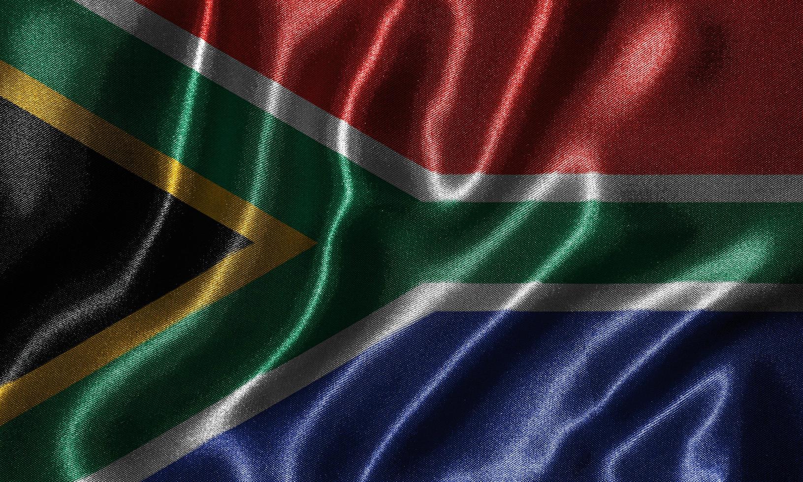 papel pintado con la bandera de Sudáfrica y la bandera ondeando por la tela. foto
