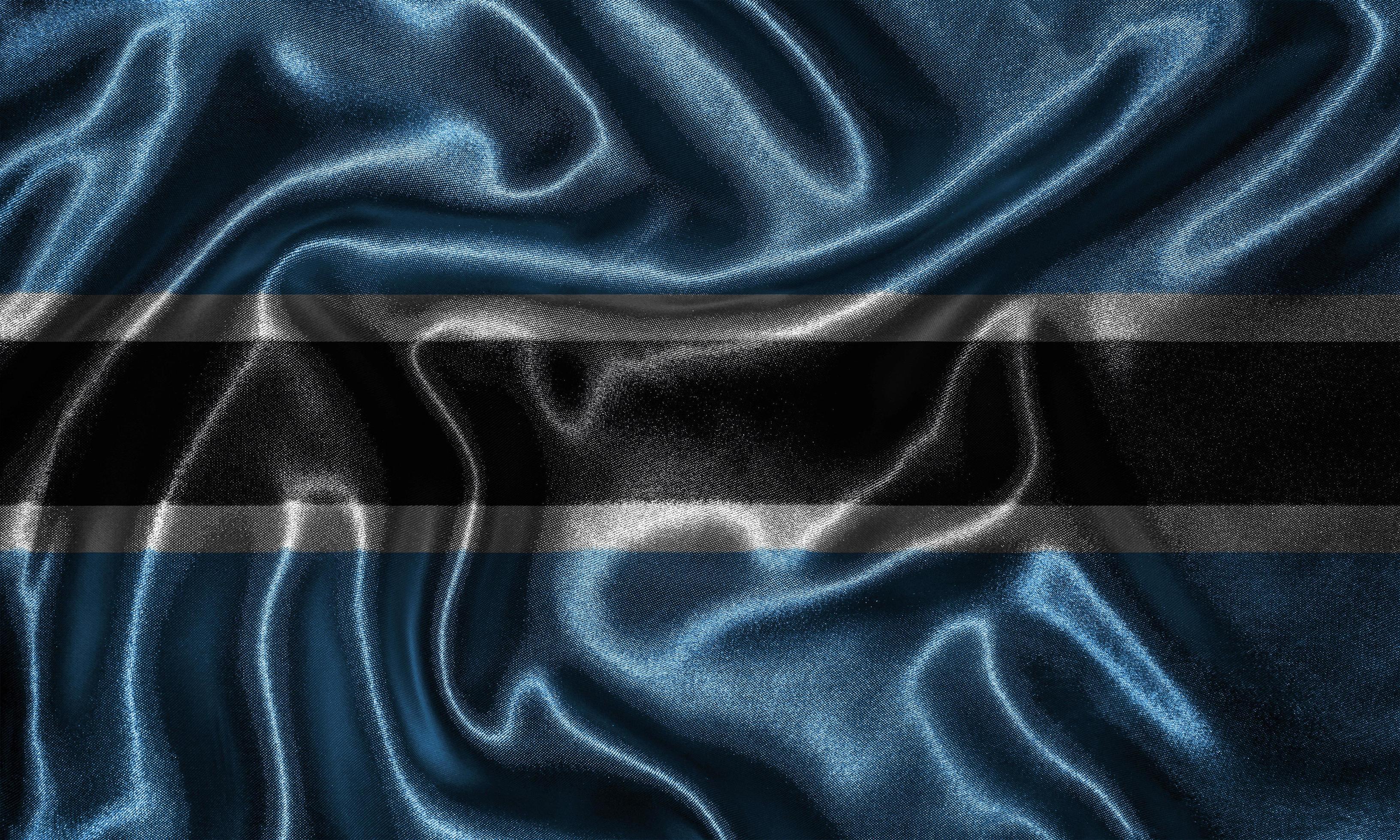papel tapiz de la bandera de botswana y bandera ondeando por tela. foto