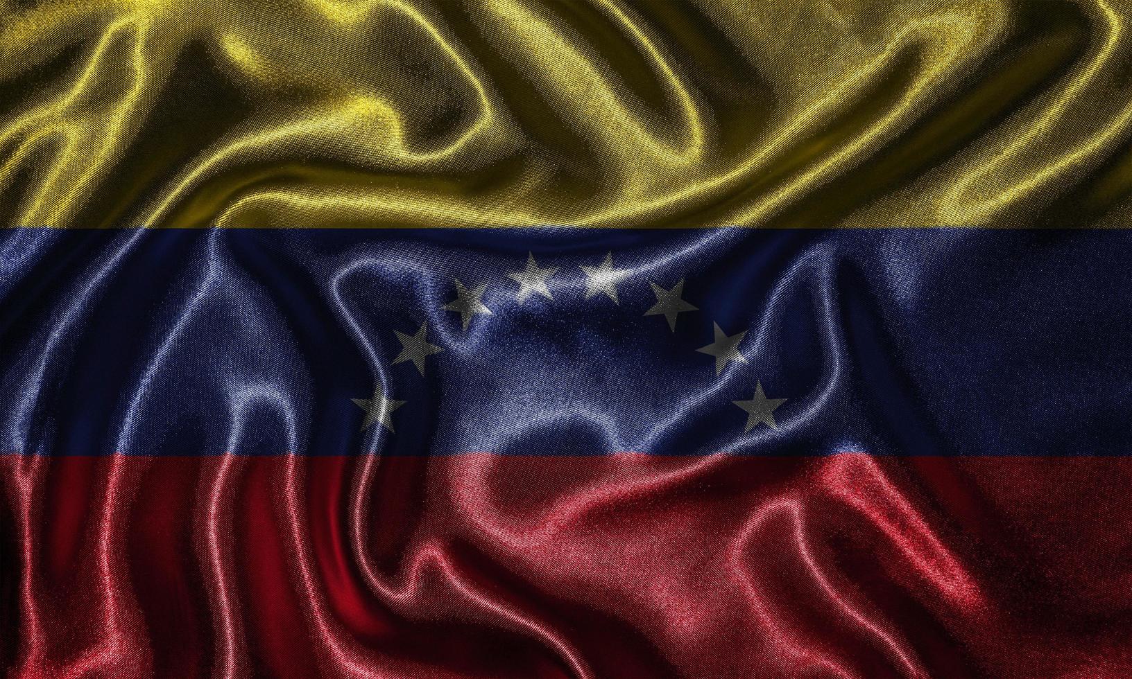 papel tapiz con bandera de venezuela y bandera ondeando por tela. foto