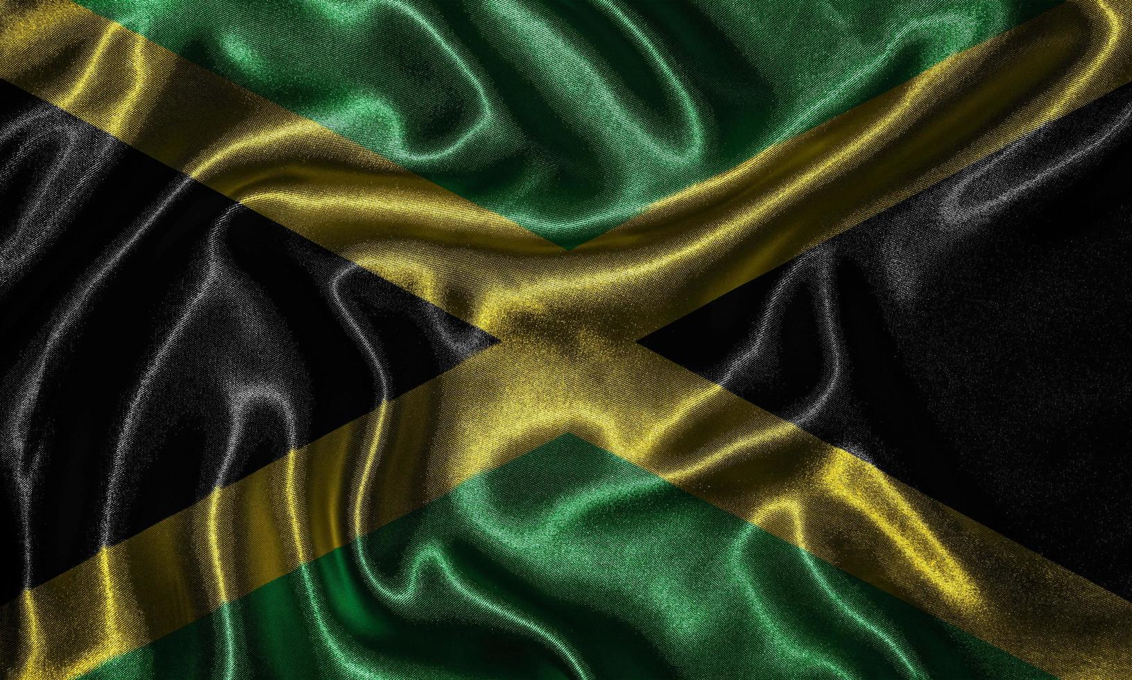 papel tapiz de la bandera de jamaica y bandera ondeando por tela. foto