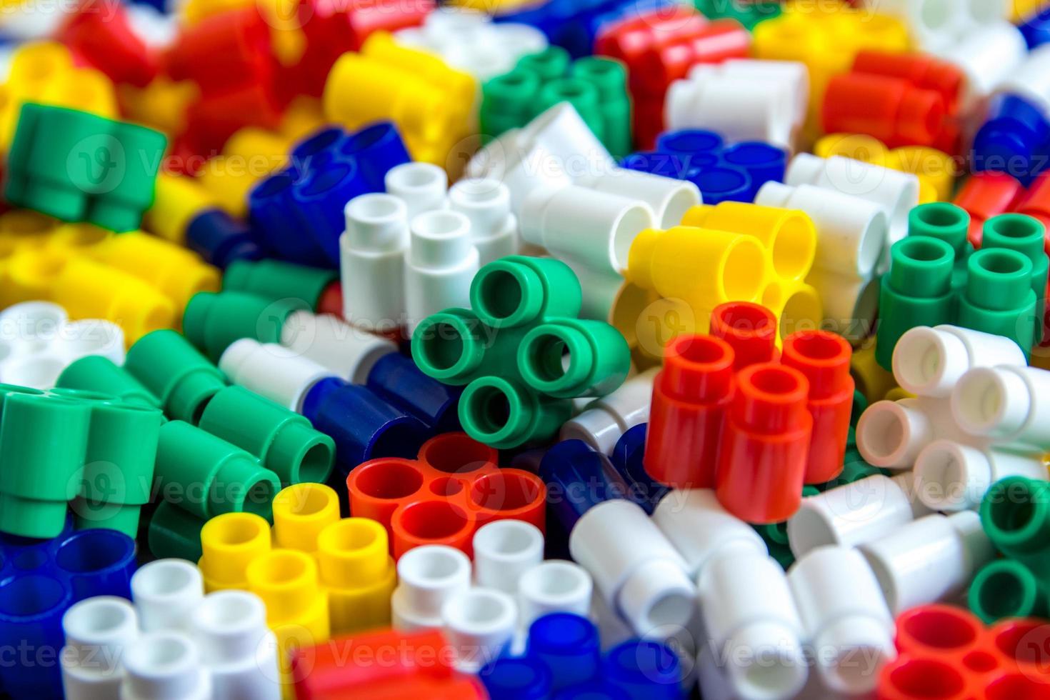 Multicolored plastic building blocks as a background texture photo