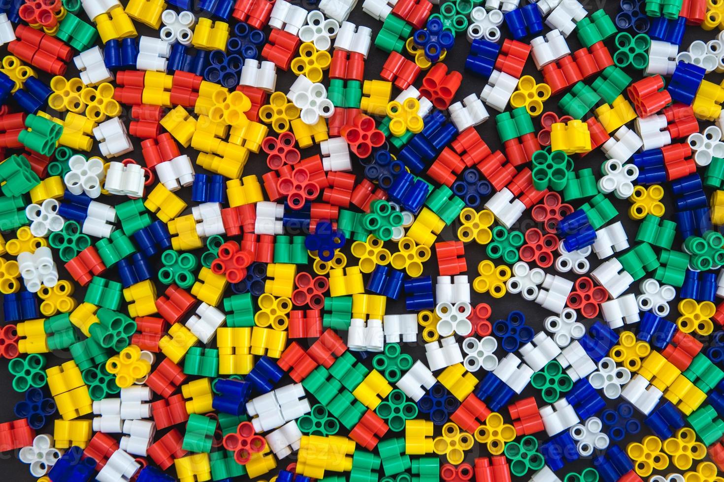 Multicolored plastic building blocks as a background texture photo