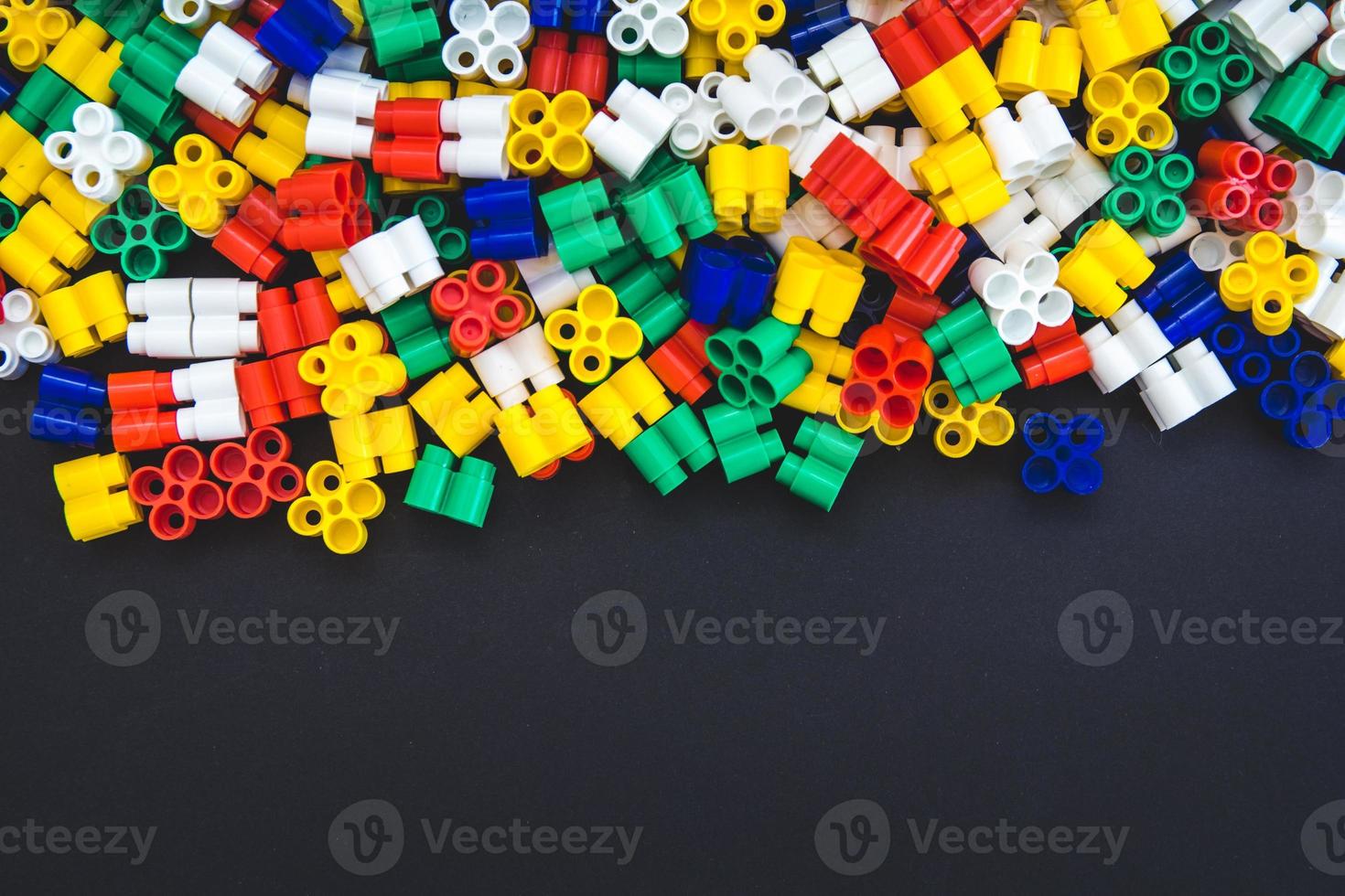 Multicolored plastic blocks on a black background photo