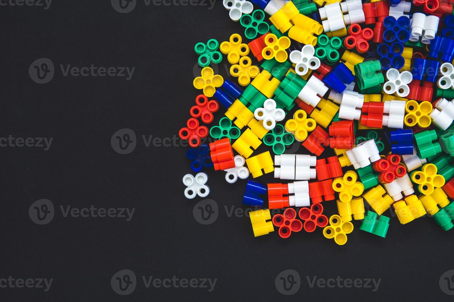 Multicolored plastic blocks on a black background photo