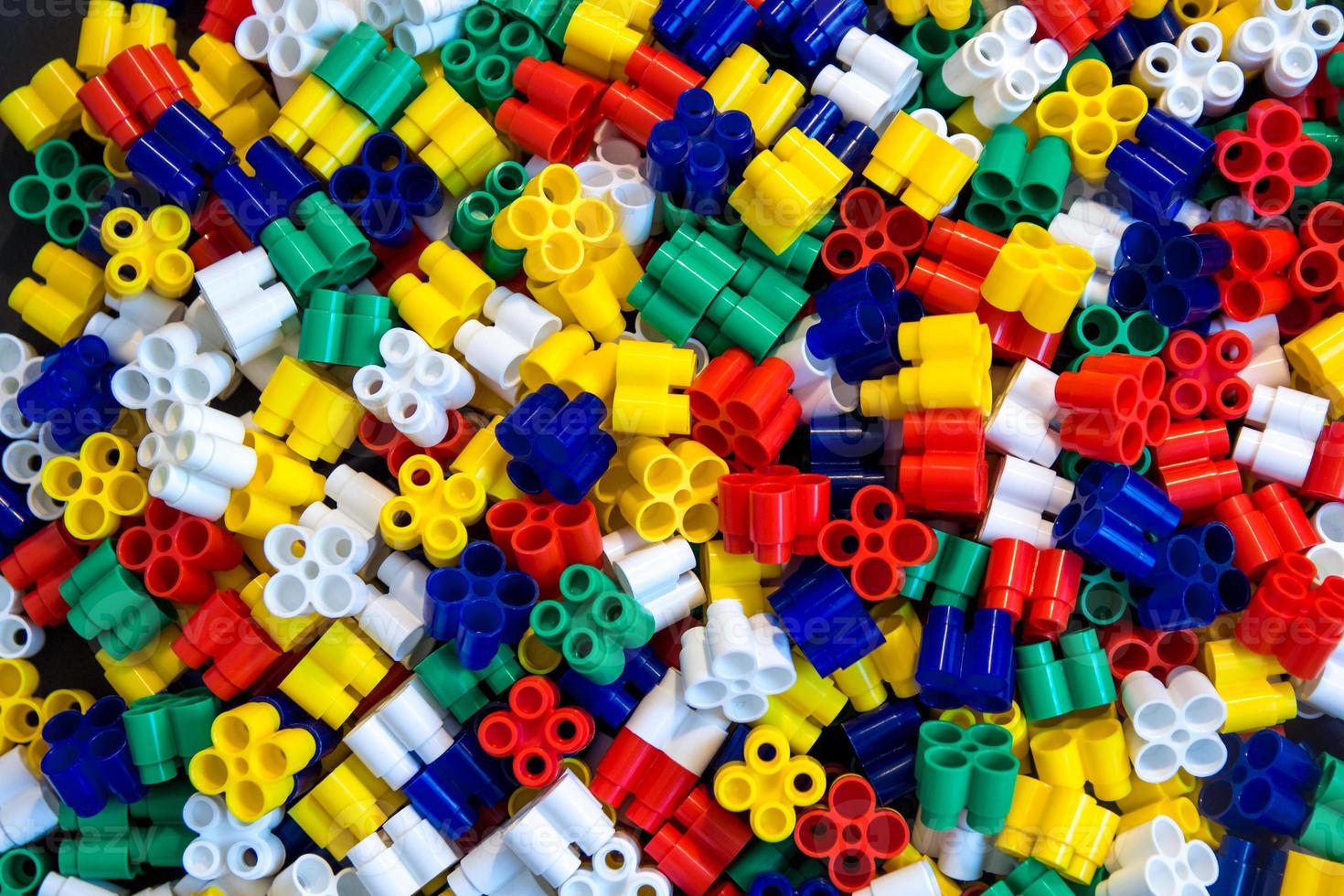 Multicolored plastic building blocks as a background texture photo