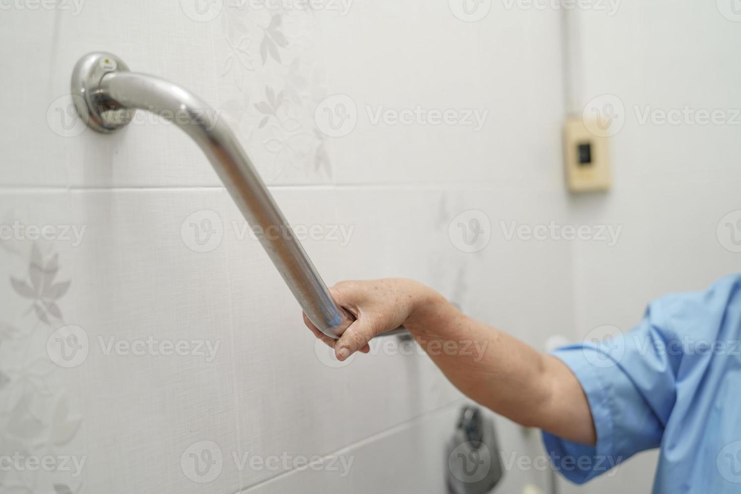 Asian senior woman patient use toilet bathroom handle security photo