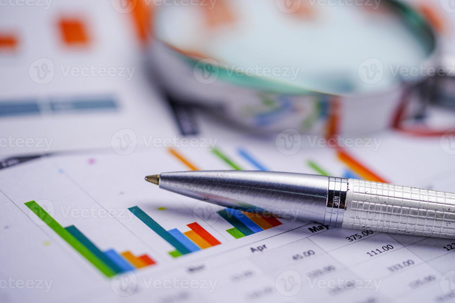 Pen on chart or graph paper. Financial account business data. photo