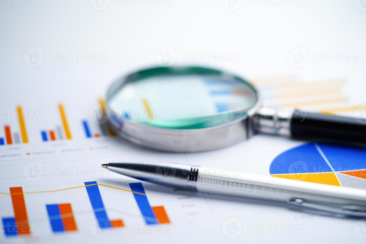 Pen on chart or graph paper. Financial account business data. photo