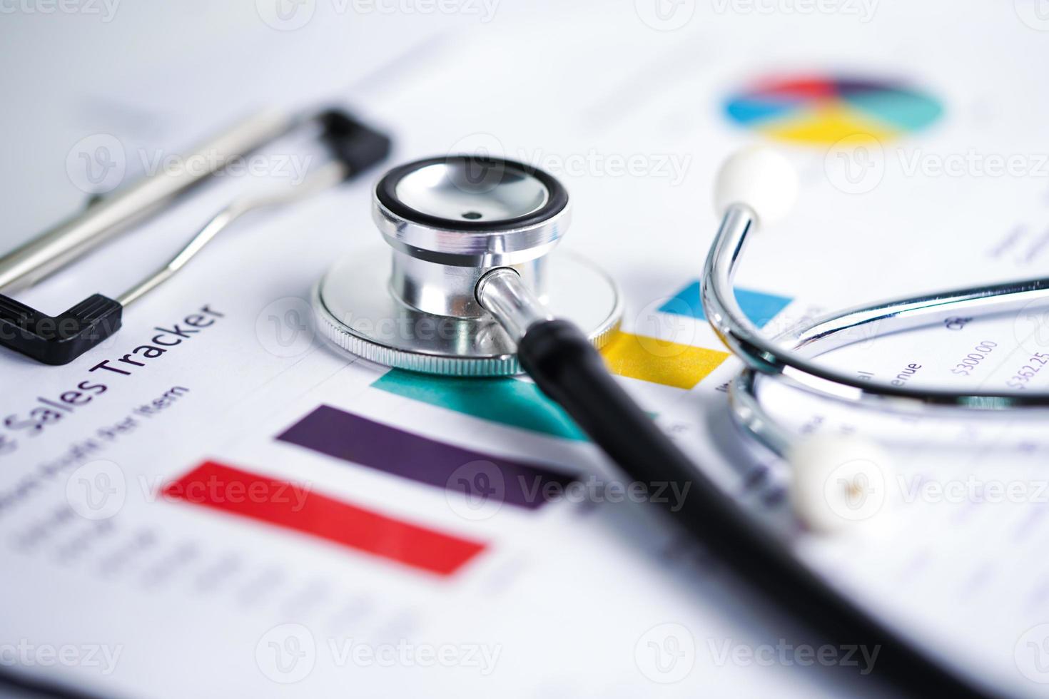 Stethoscope on graph paper. Financial account business data. photo