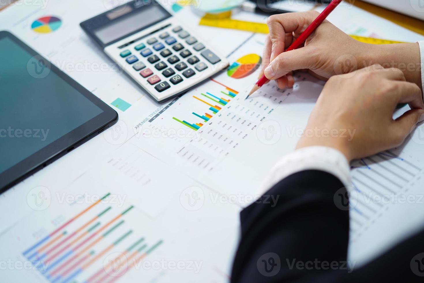 Asian accountant working and analyzing financial reports project photo