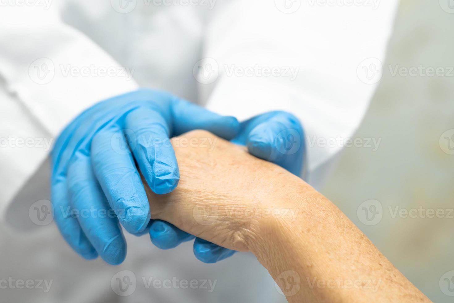 Doctor holding touching hands Asian senior woman patient with love photo