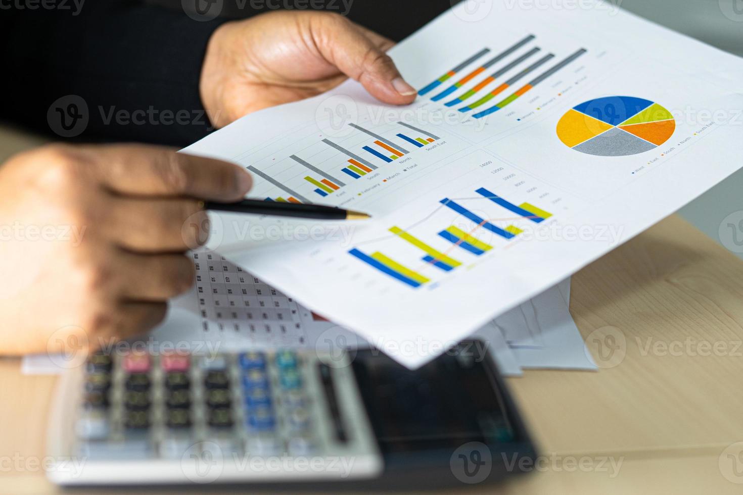 Asian accountant working and analyzing financial reports project photo