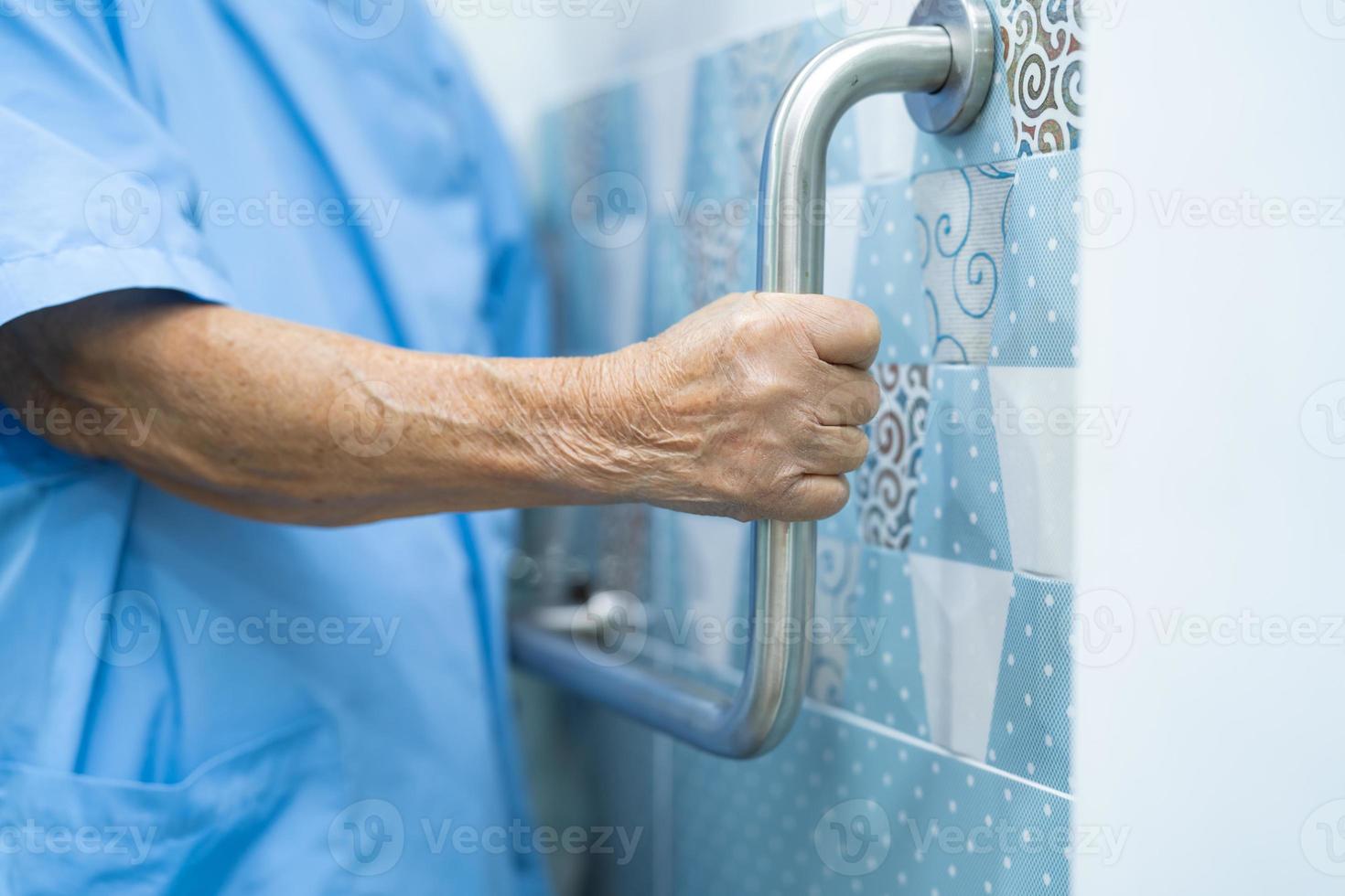 Asian senior woman patient use toilet bathroom handle security photo