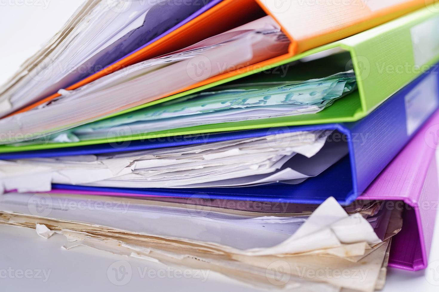 File Folder Binder stack of multi color on table in office. photo