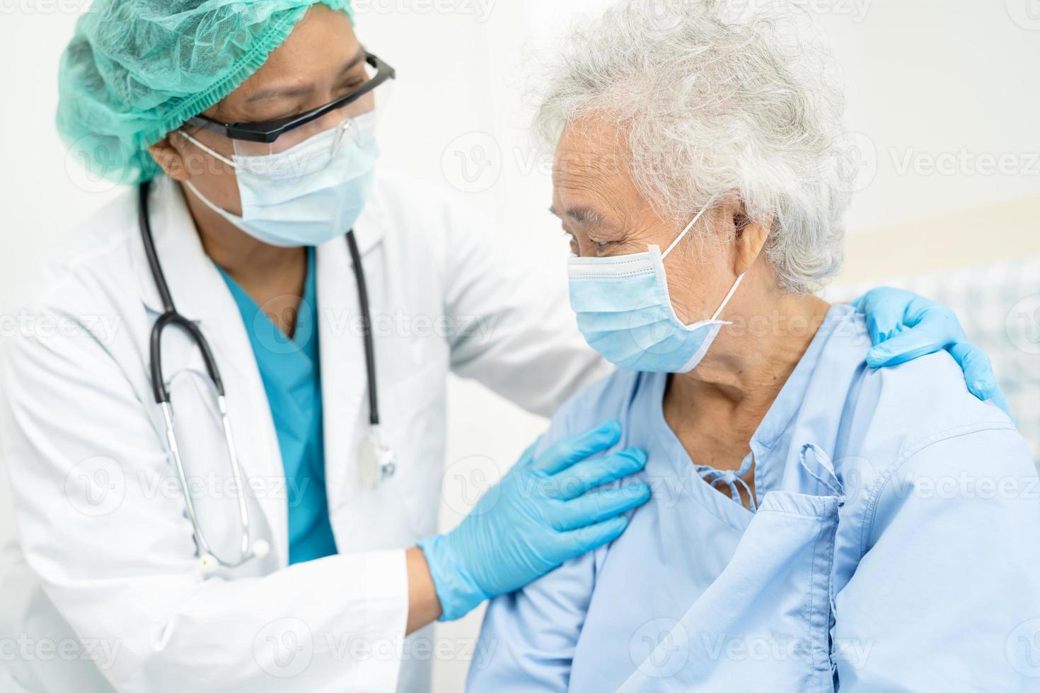 Doctor help Asian senior patient wearing mask for protect Coronavirus. photo