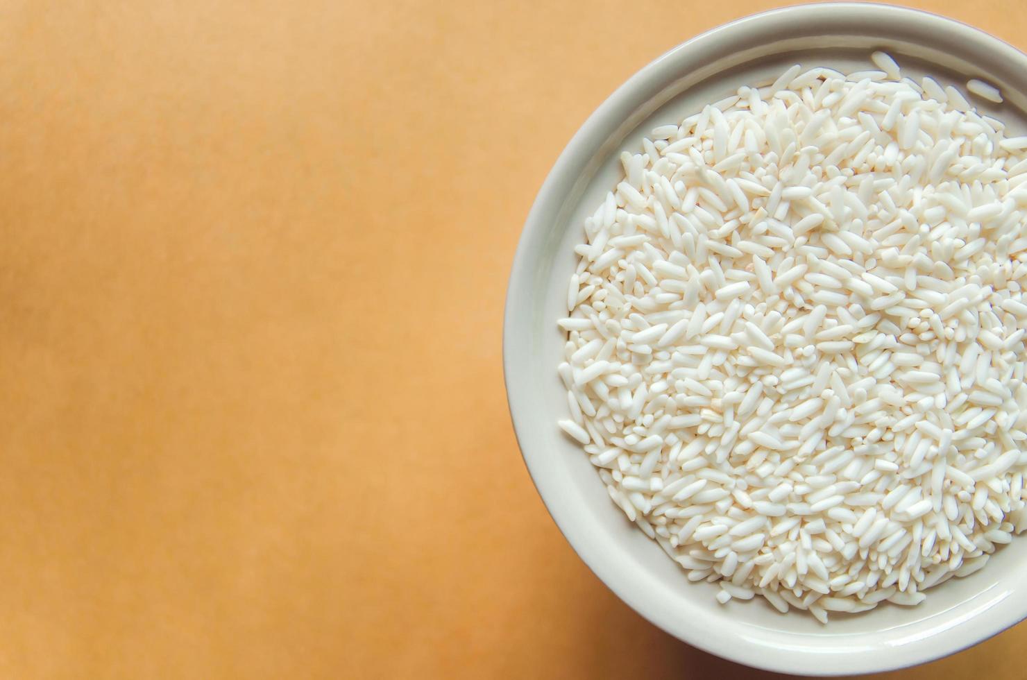 Top view of paddy rice and rice seed on the wooden floor photo