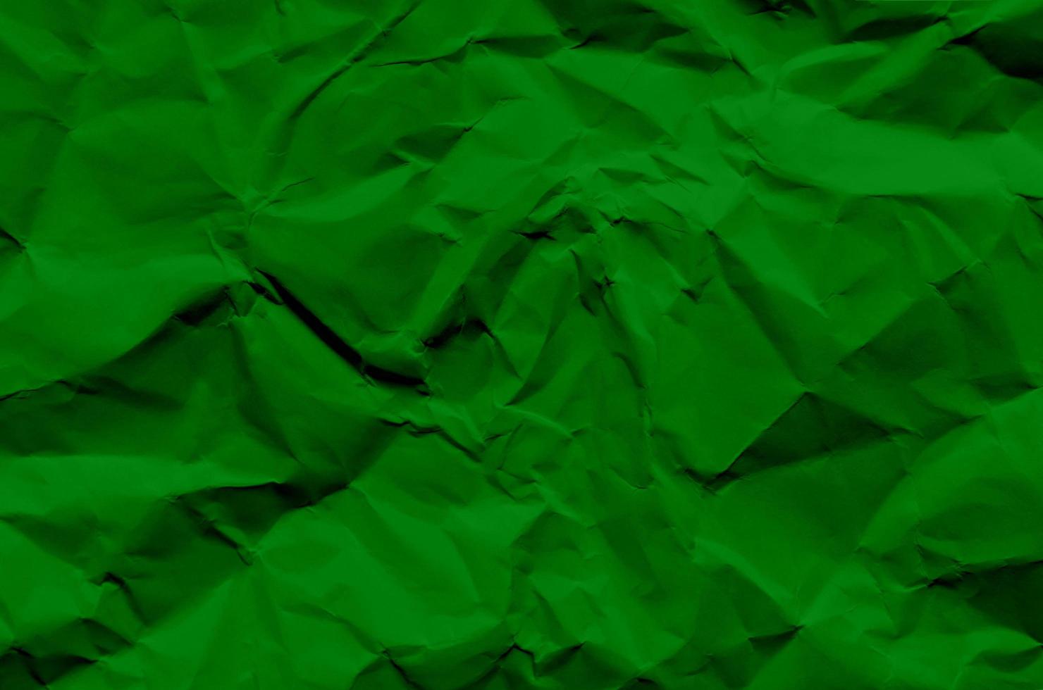 Fondo verde y papel tapiz de textura de papel arrugado. foto