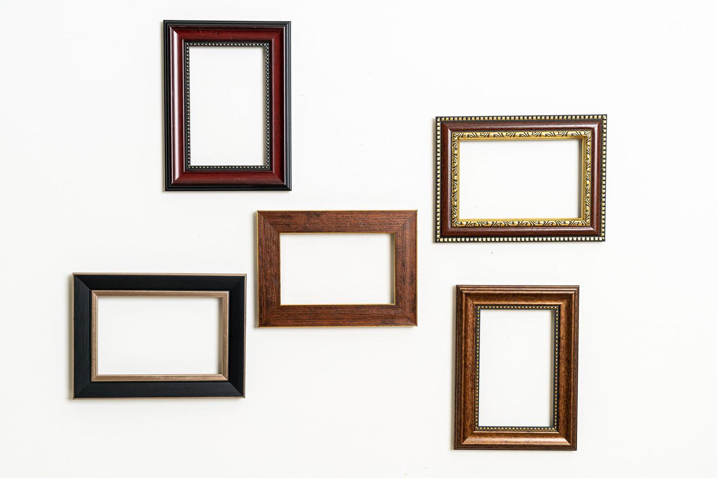 Empty picture frame on white wall background photo