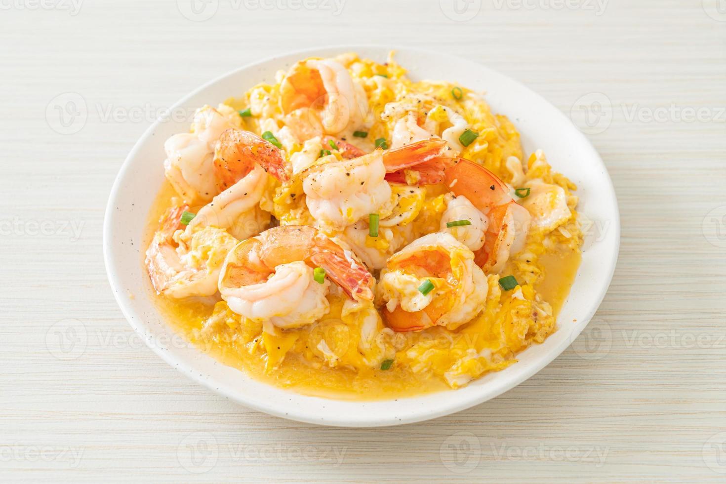 Creamy omelet with shrimps or scrambled eggs and shrimps photo