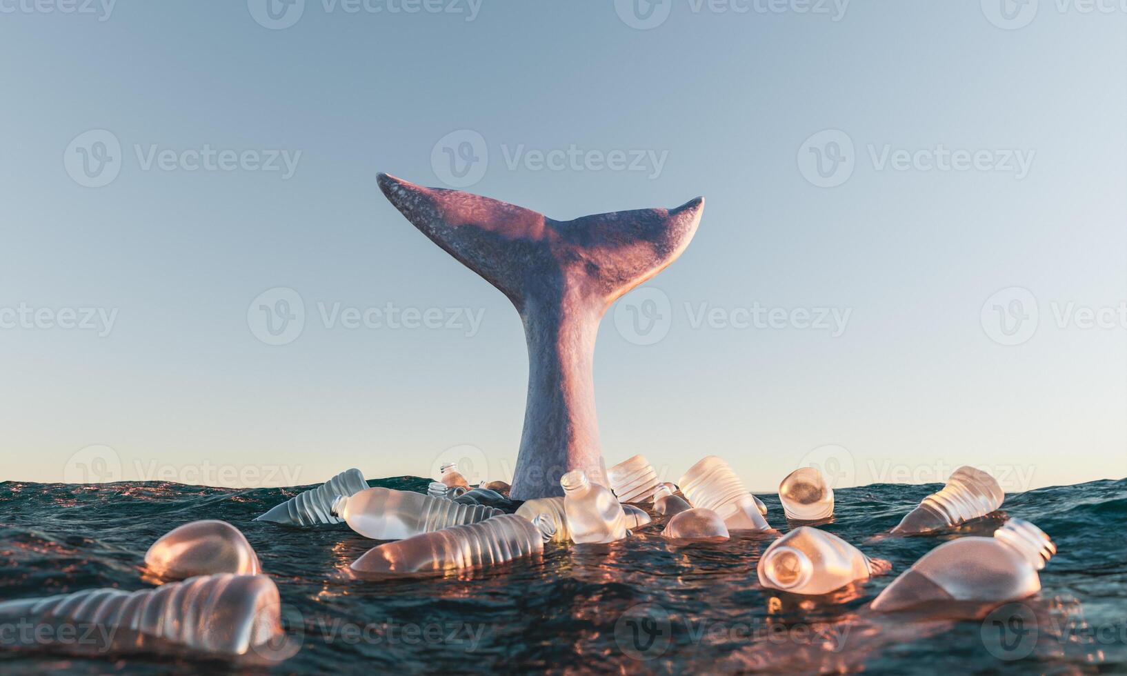 Cola de ballena en el océano rodeada de botellas de plástico. foto