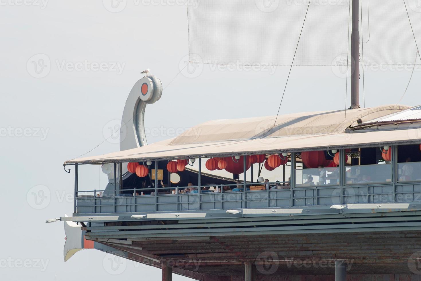 Restaurant in the shape of ship with a sail on the embankment photo