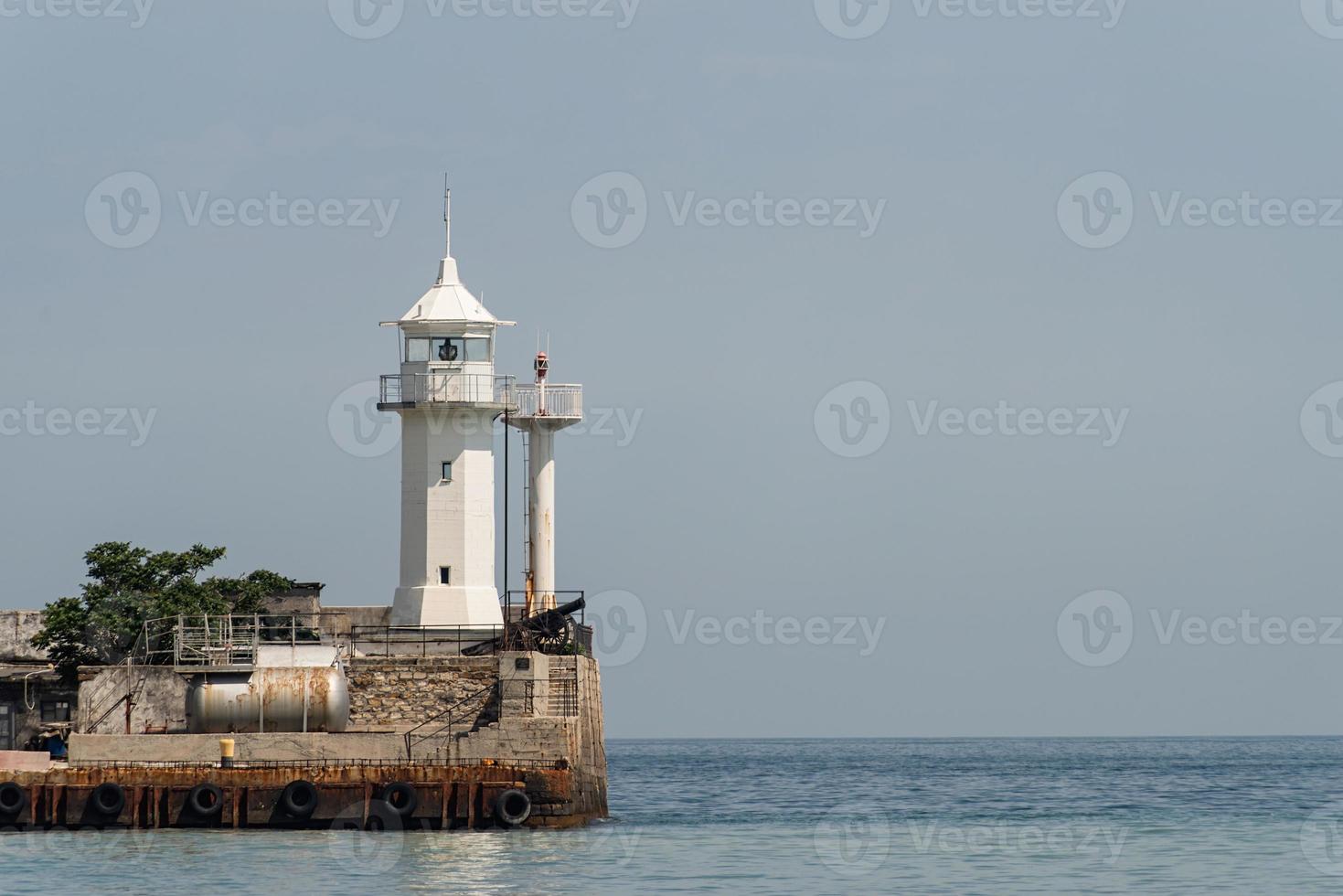 Old lighthouse on sea coast photo